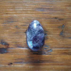 Amethyst Yoni Egg on Wooden Background