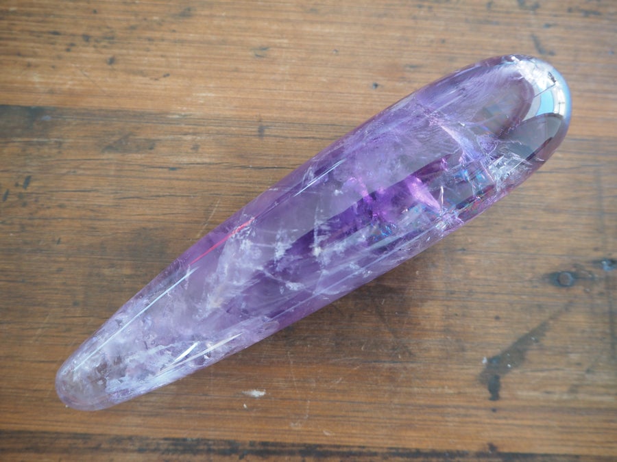 Amethyst Crystal Dildo On Wooden Background 